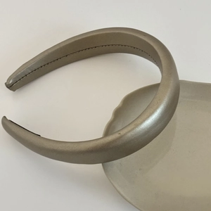 Detail view of champagne gold leather headband with padded design and anti-slip lining