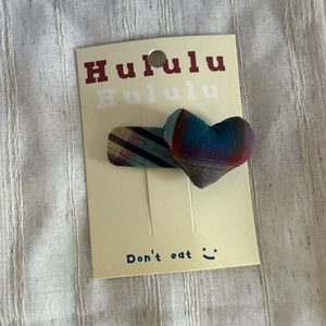 Colorful plaid bow hair clip with heart-shaped fabric padding for girls on display card