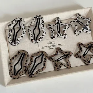 Eight-piece leopard print BB hair clip set with star and wave shapes in beige and brown