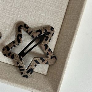 Star shaped hair clip featuring a classic leopard print fabric on a metal BB clip base