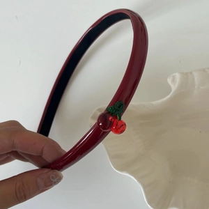 Detail of red cherry headband with transparent acrylic fruits and non-slip lining