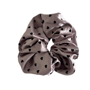 Elegant champagne satin scrunchie with black heart prints and a smooth silk texture