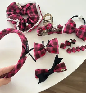 Detail of rose pink plaid hair accessories with bows and lace and pearl accents
