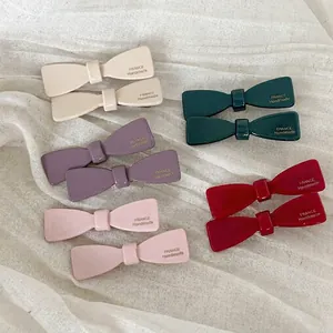 Glossy acetate bow hair clips set in elegant neutral colors for women styling
