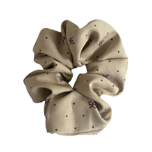 Polka dot bow pattern scrunchie in beige fabric with pleated texture for women