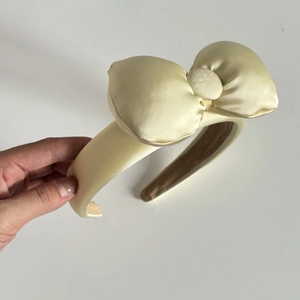 Cute cream oversized bow headband for women washing face or makeup in satin fabric