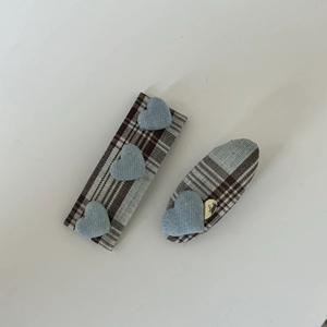 Detail of plaid fabric BB hair clips with light blue knitted heart appliques