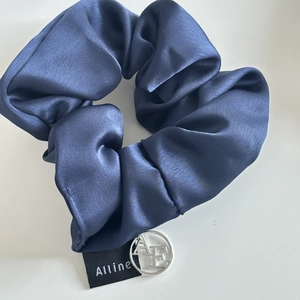 Navy blue satin hair scrunchie with silver AE metal pendant and Alline brand tag