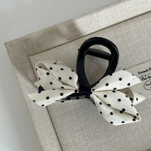 Elegant vintage polka dot bow hair claw clip with cream satin and black resin base