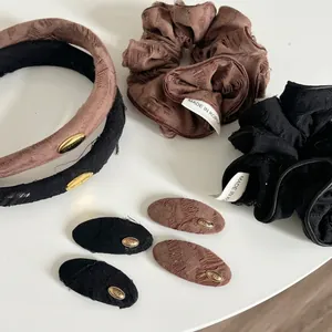 Vintage style brown and black hair accessory set with gold love tags and textured fabric