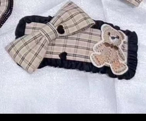 Detail view of the vintage plaid bear bow hairband with black ruffled edge and cute embroidery