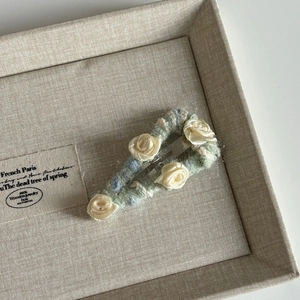 Handmade crochet floral hair clip with white silk roses on light green and blue base