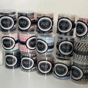 Elastic woven hair ties set in clear cylindrical packaging with diverse color options
