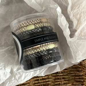Set of multi-colored high elastic hair ties with metallic weave in a clear cylinder case