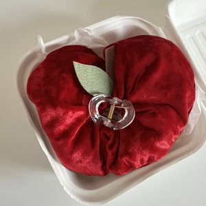 Red velvet apple-shaped hair scrunchie with green leaf in a white gift box