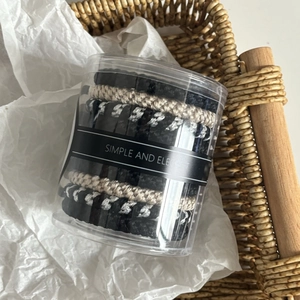 Close-up of high elasticity hair ties set in a transparent cylinder packaging box