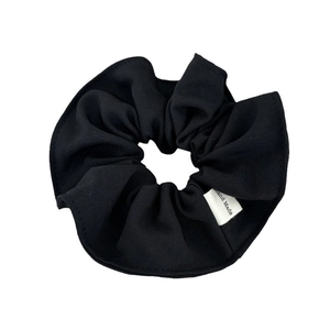 Minimalist black fabric scrunchie with handmade tag for ponytails in elegant suit material
