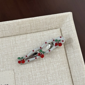 Polka dot cherry hair clip with red rhinestones and wavy white enamel finish
