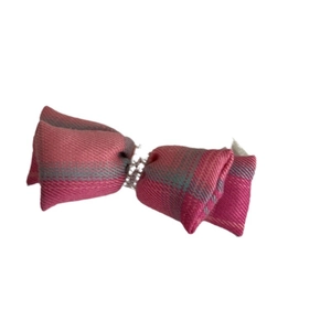 Vintage pink plaid bow hair clip with decorative silver beads on white background