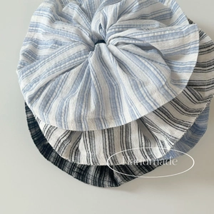 Detail view of blue and grey striped fabric hair scrunchies with soft texture