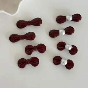 Set of 8 mini red bow hair clips with glossy finish and white faux pearl accents