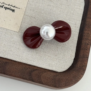 Mini vintage red bow hair clip with a large pearl accent for elegant styling