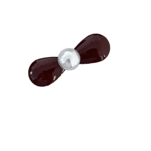 Mini red metal bow hair clip with a centered pearl for sweet and elegant styling