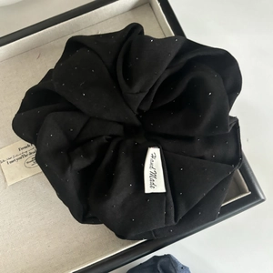 Elegant black scrunchie with rhinestones and handmade label for stylish hair styling