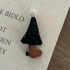 Cute handmade Christmas tree hair clip with white plush pom-pom and 3D fabric details