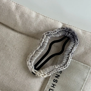 Détail de la pince à cheveux étoile tricotée avec dégradé gris et texture au crochet