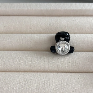 Mini pince à cheveux noire élégante ornée d'un grand strass facetté et bordure en métal argent