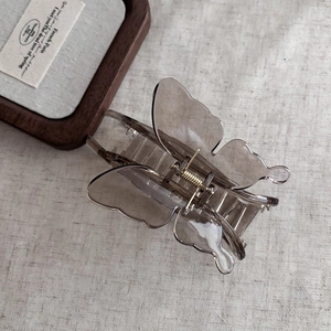 French vintage butterfly hair claw clip in translucent grey acrylic with golden spring