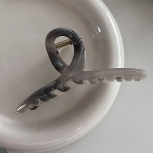 Elegant marble grey ink hair claw clip in a white ceramic dish for stylish hair styling