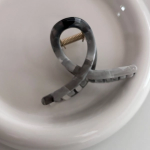 Macro detail of the grey marble ink texture on the crisscross hair claw clip