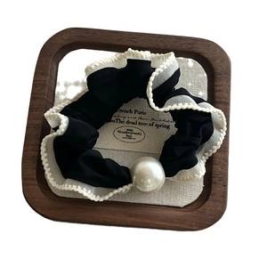 Elegant black ruffle hair scrunchie with white lace trim and a large pearl ornament
