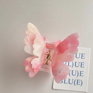 Pink and white marble butterfly hair claw clip with subtle glitter and gold spring