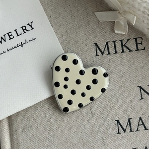 Sweet cream yellow heart brooch with black polka dots and metal edging on a card