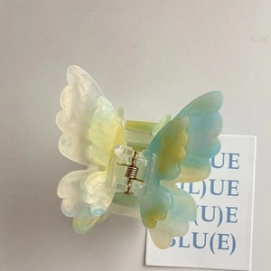 Elegant butterfly acetate hair claw clip with blue and yellow marble texture for women