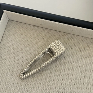 Elegant silver metal hair clip with sparkling rhinestones in a hollow triangle design