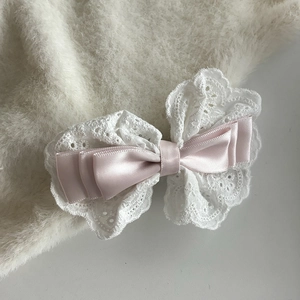 Détail de la pince à cheveux noeud en satin rose avec dentelle blanche et clip bec de canard
