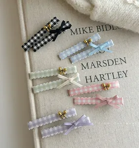 Detail showing colorful plaid hair clips with metal and ribbon bows in ten piece set