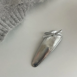Chic silver metallic leather bow hair clip with teardrop shape and minimalist design