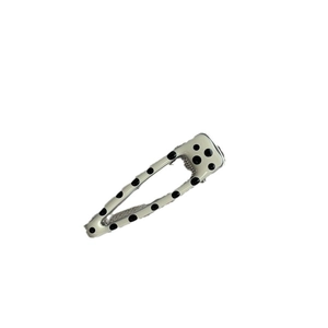 Polka dot cream hair clip with black pattern and sleek metal snap design