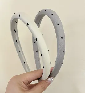 Close-up of heart and polka dot satin headbands showing soft fabric texture and patterns