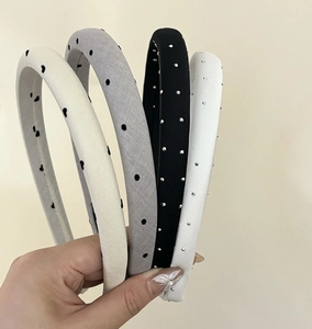 Close-up of assorted vintage satin headbands with polka dots and small rhinestone accents