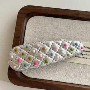 Silver quilted hair clip with colorful dots and metallic finish for women styling