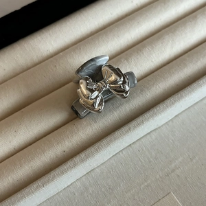 Silver bow hair claw clip with grey marble texture on a soft velvet jewelry box