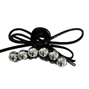 Elegant black bow hair claw clip with silver metallic beads on a white background