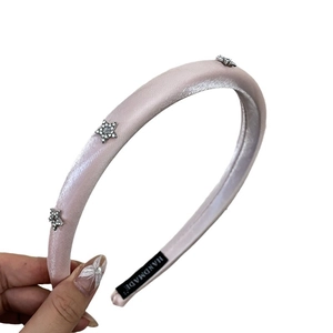 Pink satin padded headband featuring sparkling rhinestone star ornaments for women