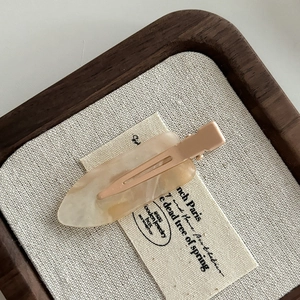 French style seamless hair clip with marble pattern on beige linen and wood tray